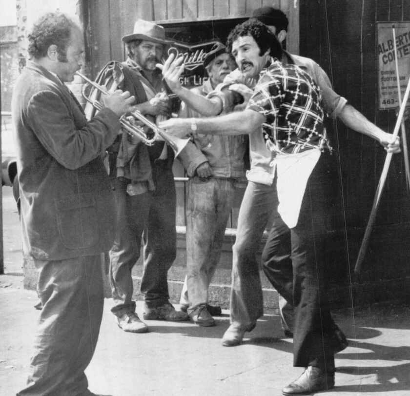 Joe Shannon (Burt Young) defiantly plays his trumpet after he’s bounced from a skid row bar in ‘Uncle Joe Shannon.’’