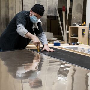 Brian Schuth, a carpenter at Pac Team, cuts the plastic to make face shields at the factory at 4447 W. Armitage Ave. on the Northwest Side, Tuesday afternoon, March 31, 2020.