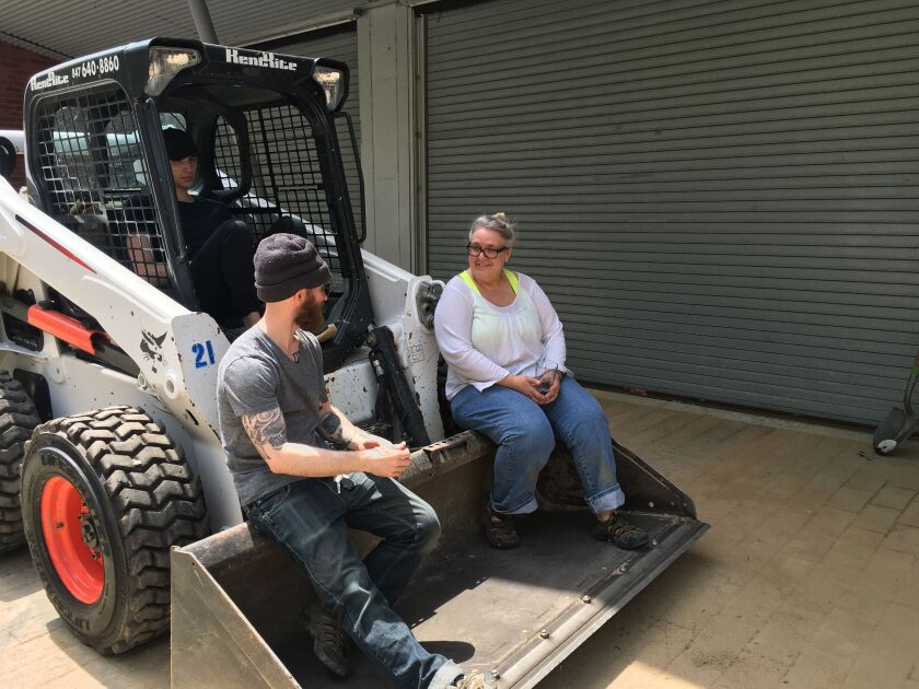 Peter Reese (left), preparator at the Hyde Park Art Center; Will Krauland, exhibitions preparator intern at the Hyde Park Art Center and a student at the School of the Art Institute of Chicago; and artist Karen Reimer wait for more sand to be delivered du