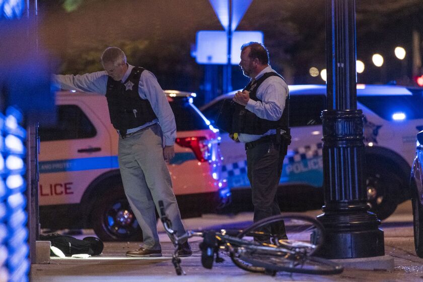 Chicago police work the scene where at least 6 people were shot in the 2000 block of East 71st Street in the South Shore neighborhood, Sunday, June 27, 2021.