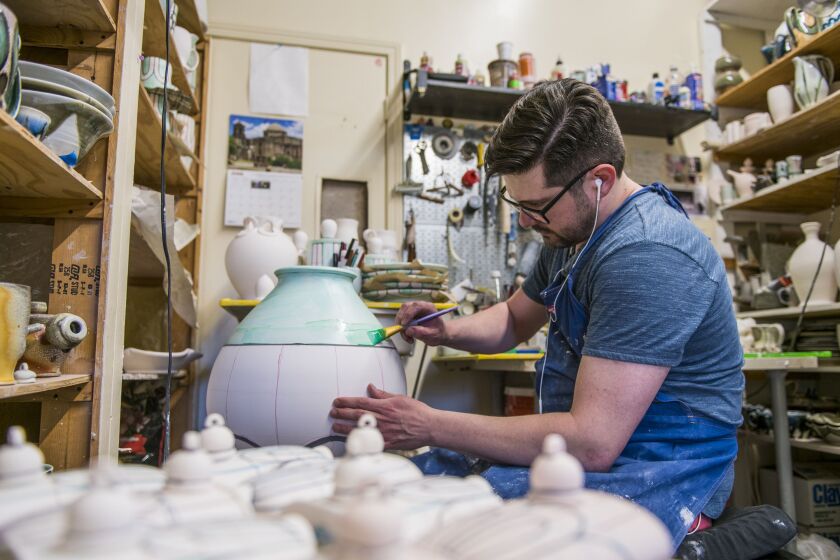 Nolan Baumgartner a resident artist and instructor at Lillstreet Art Center glazes a ceramic pot in his personal studio at the Lillstreet. | Tyler LaRiviere/Sun-Times