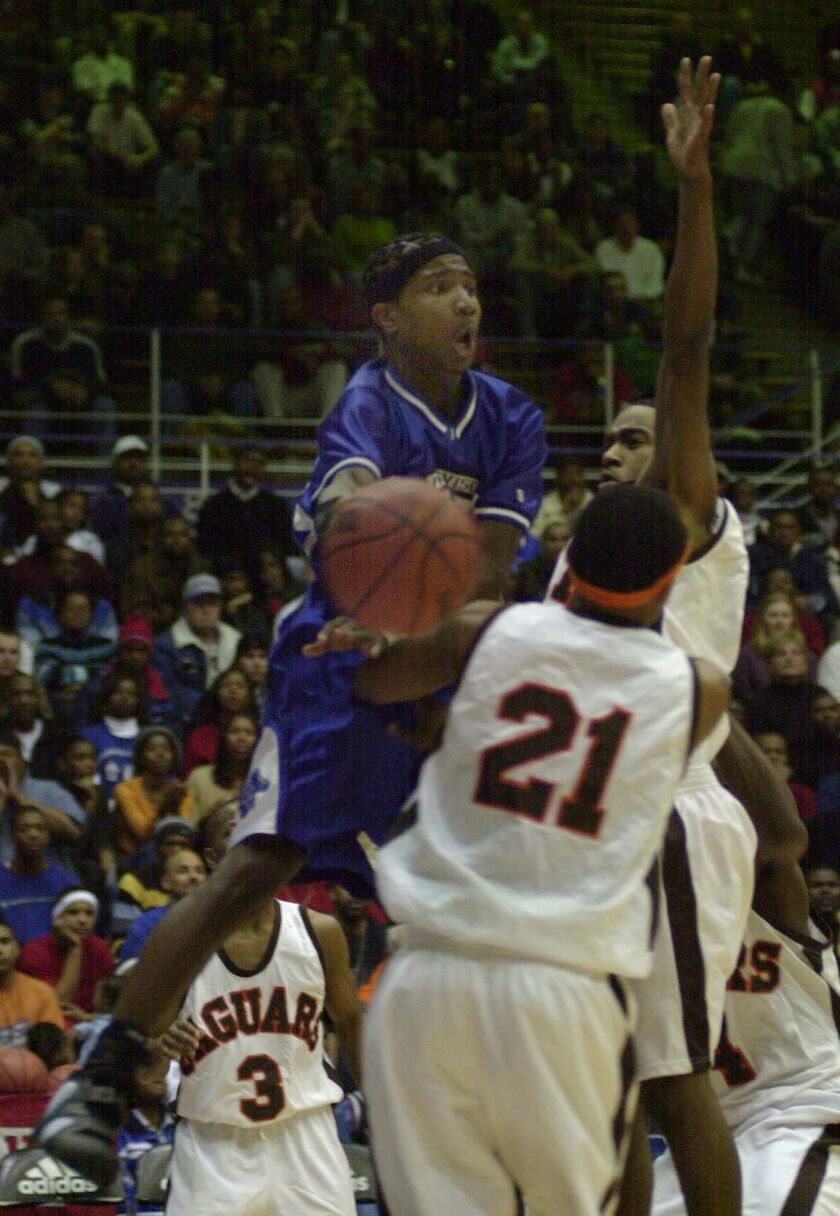 Proviso East’s Dee Brown goes up for a pass around Julian’s Karl Brown.