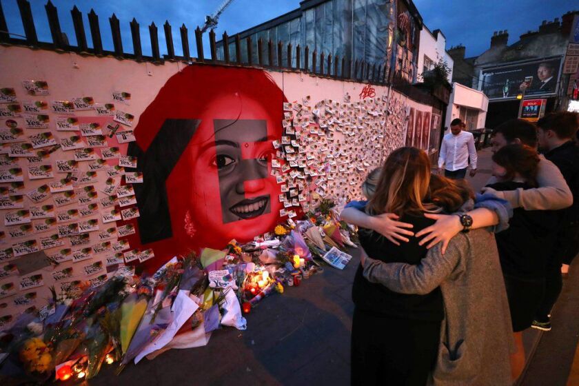 Candles and flowers are placed in front of a mural of Savita Halappanavar in Dublin, Ireland, Saturday, May 26, 2018. | Niall Carson/PA via AP