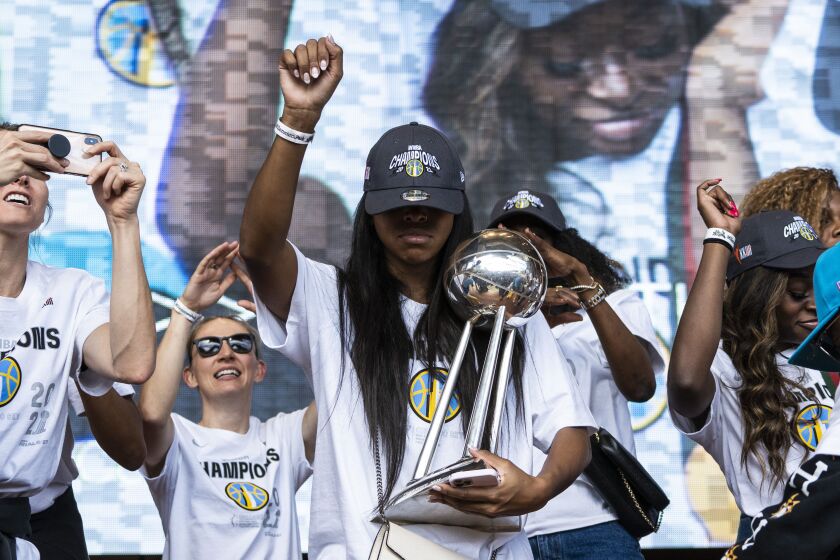 Lexie Brown poses with the championship trophy.