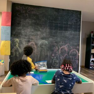 Ayden looks at a chalkboard with his family.
