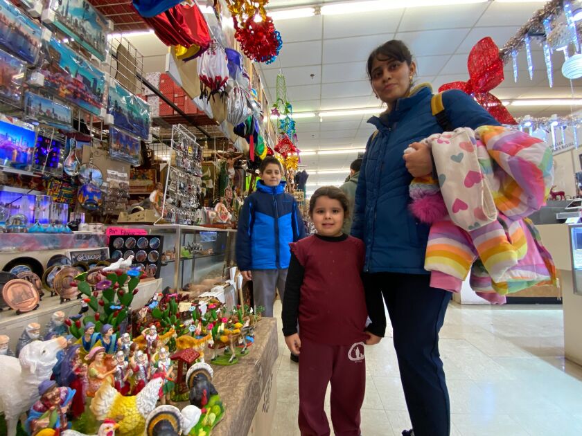 Luz Adame and daughter Odalis shop for nativity scene decorations at the Little Village Discount Mall Thursday.