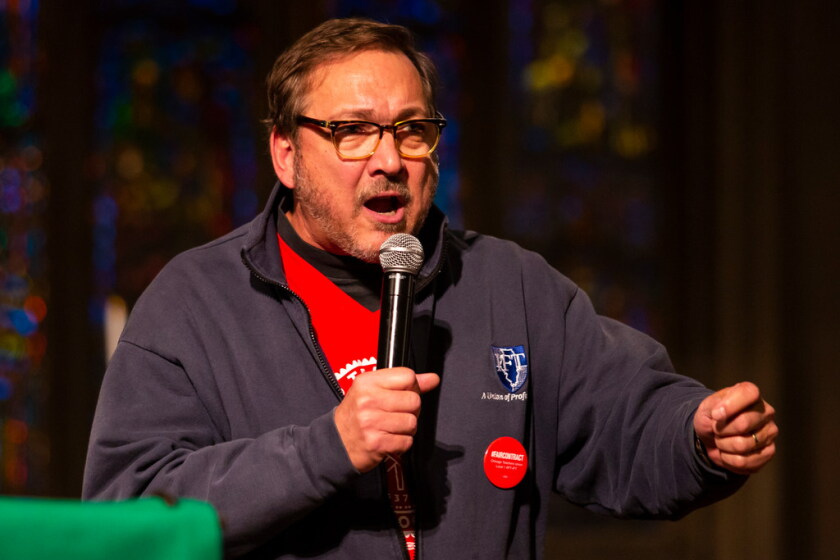 A man, Dan Montgomery, speaks into a microphone that he holds in his hand.