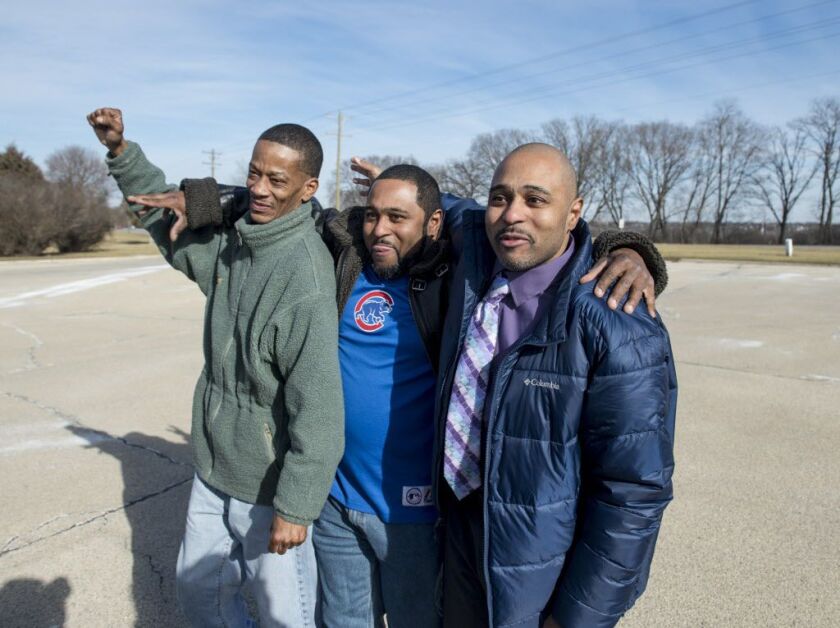 Corey Batchelor (from left) Keith Bailey and Kevin Bailey have an emotional reunion after Kevin was released from Statesville Correctional Center on Tuesday, January 30, 2018.