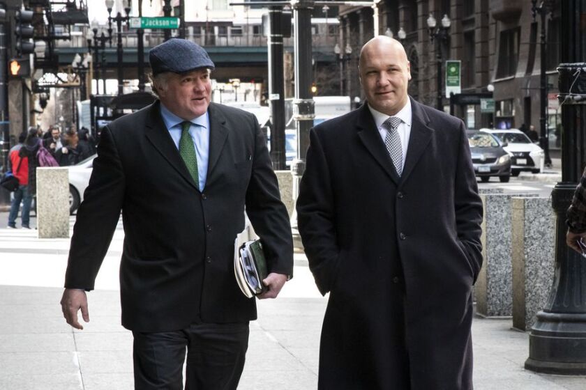 Casey Urlacher (right) walks with his attorney, Michael Gillespie, into the Dirksen Federal Courthouse.