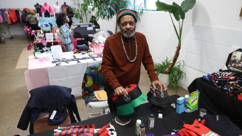 Derrick Riley, owner of Chicago Matah, sells clothes, books and other items at Saturday's Kwanzaa celebration.