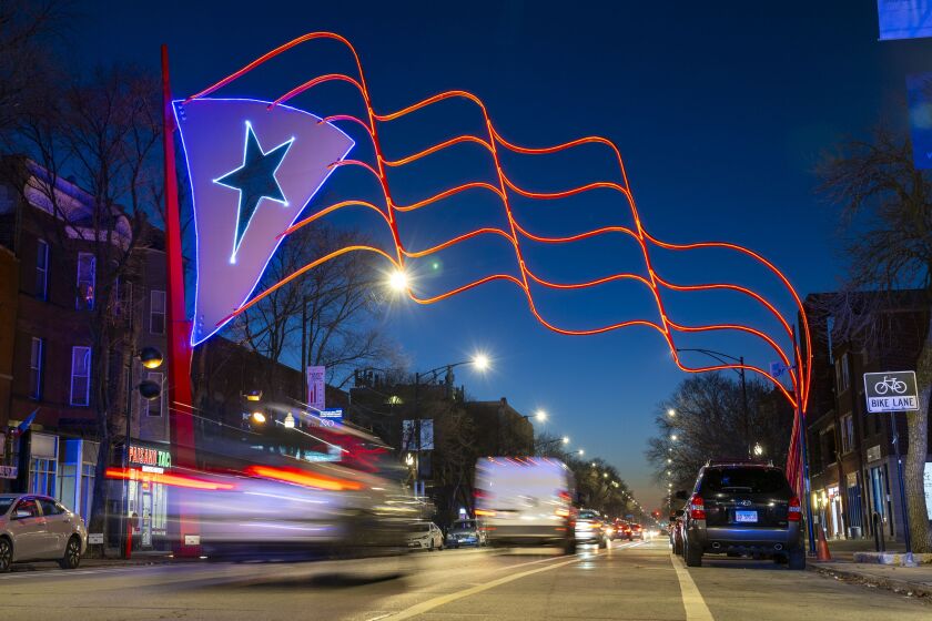 The Humboldt Park Puerto Rican flag at Western and Division, which acts as the neighborhood’s gateway, is lit up for the first time since its installation in 1995, Thursday, Dec. 14.