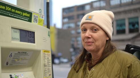 A consumer stands next to a gas pump at a BP station.