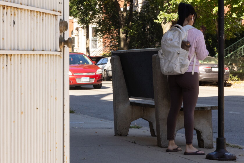 A woman waits for the bus next to an ADA-compliant bench at the North Damen Avenue and West Thomas Street stop in Ukrainian Village on the North Side, Tuesday, Oct. 6, 2026.