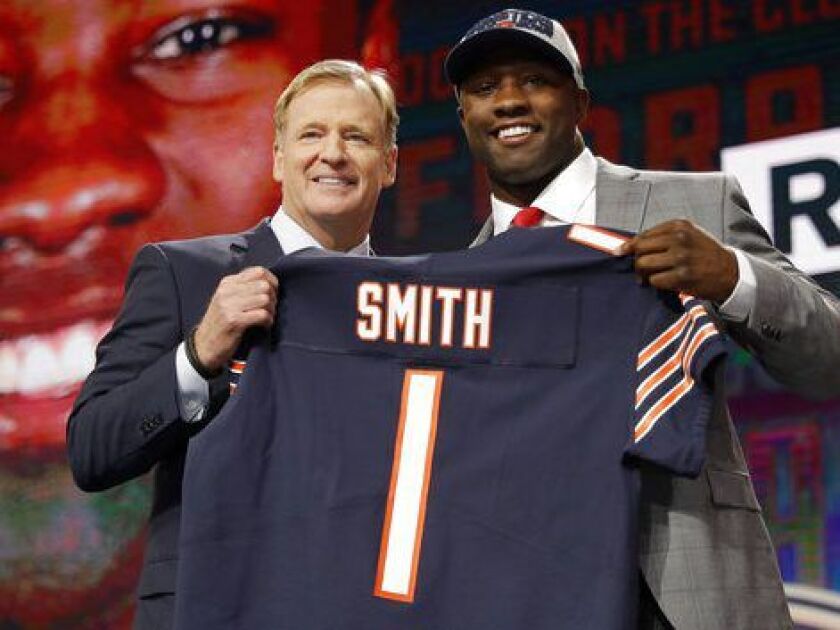 NFL commissioner Roger Goodell (left) presents Georgia’s Roquan Smith with his Bears jersey during the first round of the NFL Draft in April. | AP Photo/David J. Phillip