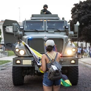 Officers with the Kenosha County Sheriff’s Department approach in an armored vehicle as protesters peacefully gather at Civic Center Park on the fourth day of civil unrest after police shot Jacob Blake, Wednesday evening, Aug. 26, 2020. The officers left a short time later without any skirmishes with the protesters.
