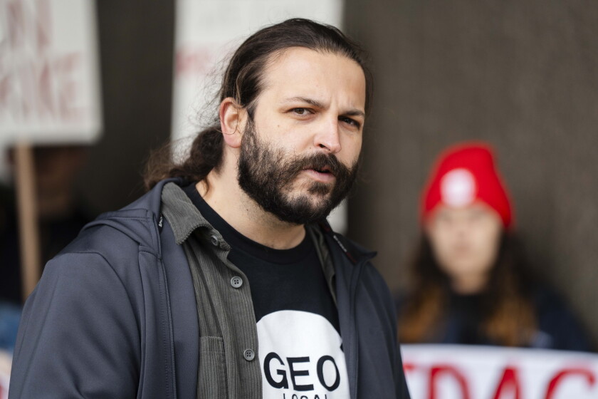 Alex Hagan speaks at a rally for striking graduate workers at the University of Illinois Chicago.