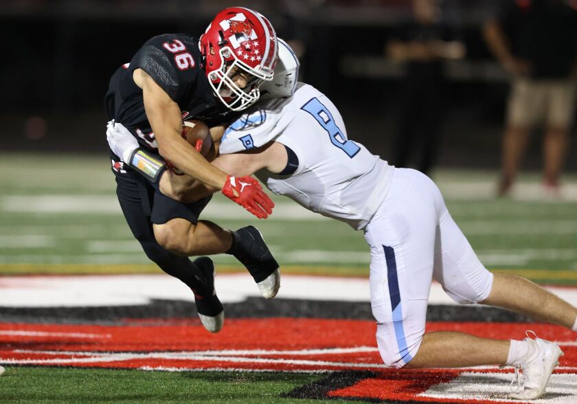 Prospect’s Conor Mitchell (8) puts a big hit on Maine South’s Michael Dellumo (36).