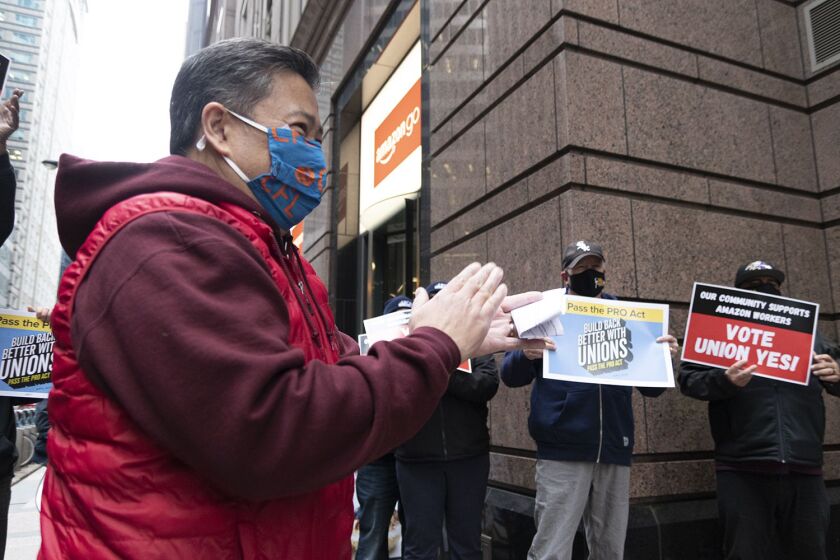 Chicago Federation of Labor Secretary-Treasurer Don Villar leads union workers in protest outside of the Chicago Amazon corporate office and Amazon Go store Friday, March 26.