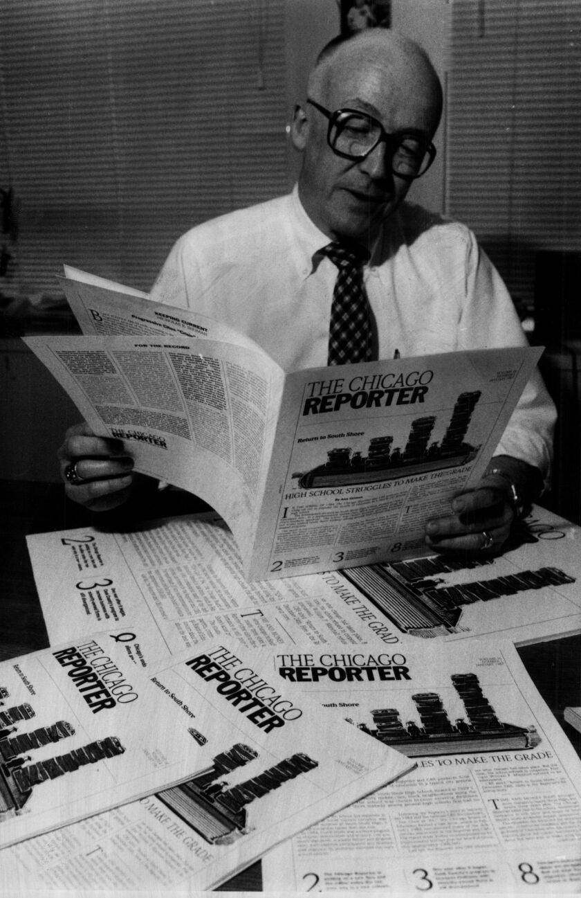 Roy Larson, editor and publisher, examining an issue the Chicago Reporter.