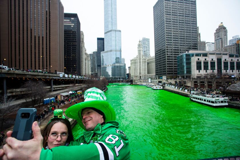 Stacey Peterson and Kevin McGuire take a selfie with the green Chicago River to celebrate St. Patrick’s Day, Saturday, March 17, 2018.