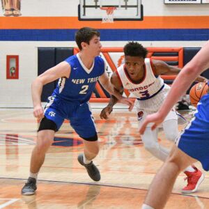 New Trier’s Noah Osher (2) tries to cut off the lane from Curie’s DaJuan Gordon (3), Friday 12-28-18. Worsom Robinson/For Sun-Times