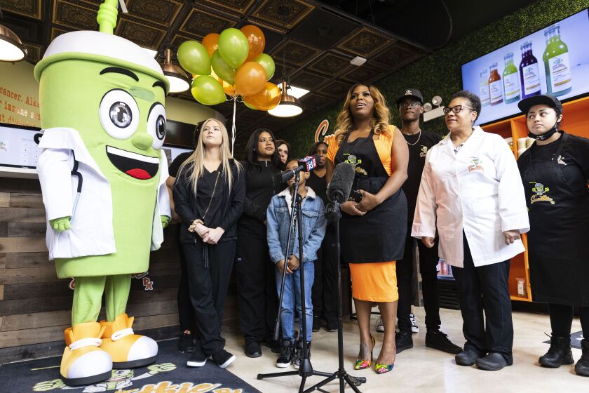 Candice Payne speaks about her motivation to open Organic Smoothie RX and what she hopes to achieve during a news conference at the shop at 1503 S. Michigan Ave. in the South Loop, Thursday, April 28, 2022.