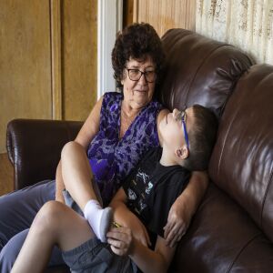 Danuta Kalinowska hugs her 12-year-old grandson Oliwier “Oli” Kluzik at their Northwest Side home.