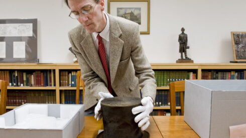 James M. Cornelius shows the Abraham Lincoln hat in 2012.