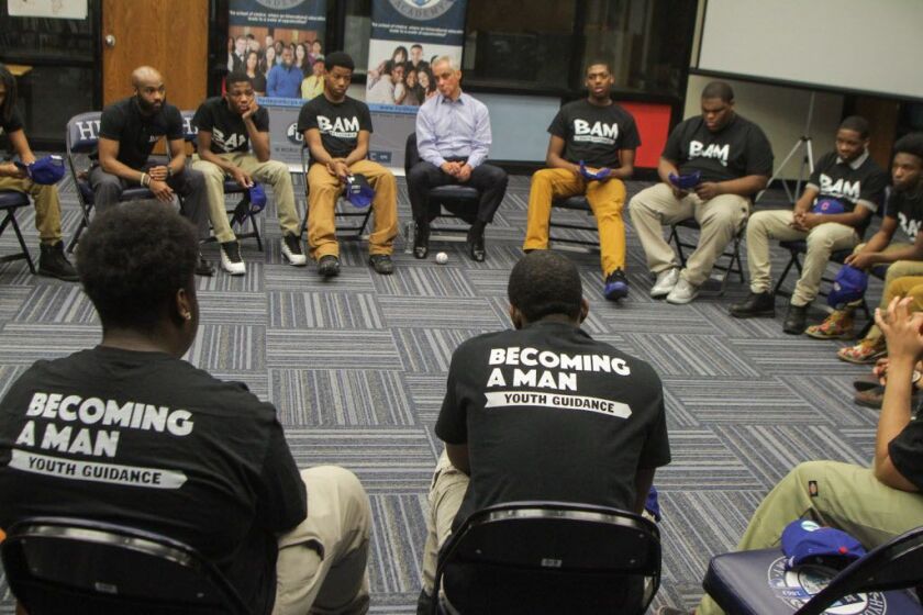 A circle is formed to kick off the Becoming A Man (BAM) meeting at Hyde Park Academy High School. It is a Youth Guidance Program at the school. Mayor Rahm Emanuel and Theo Epstein, President of Baseball Operations for the Chicago Cubs were present on Wedn
