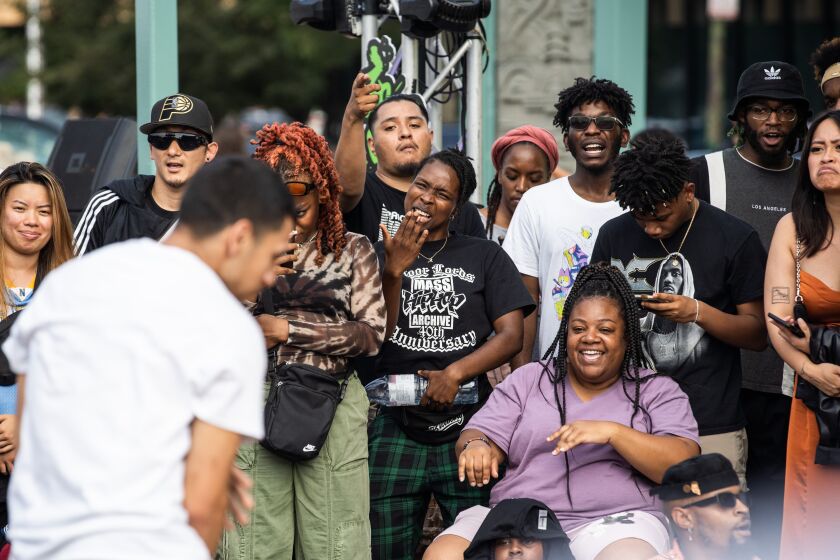 People cheer as a hip-hop dancer performs during “Youth of Chinatown,” a three-day event featuring hip-hop and K-pop performances at Chinatown Square Plaza, Saturday, Aug. 27, 2022.