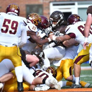 Joliet Catholic’s Keenan Hailey (27) gets tackled. Worsom Robinson/For the Sun-Times.