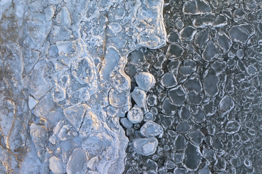 Pancake ice lines the North Avenue Beach Pier on Thursday.