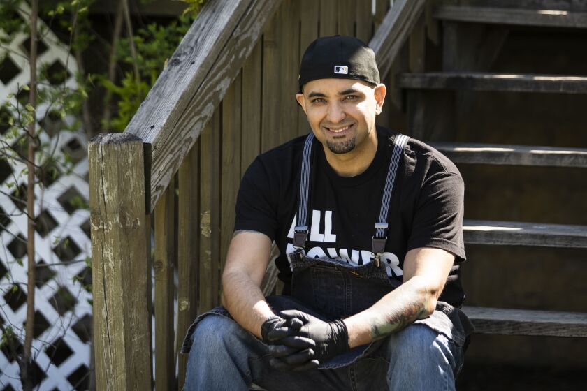 Chef Roberto Pérez, founder of Urban Pilón, poses for a portrait outside his Austin neighborhood home, where he prepares food for the Farm, Food, Familias (Granja, Comida, Familia) project, Wednesday morning, May 13, 2020. The project aims to deliver hot, free meals in areas hardest hit by COVID-19, including Englewood, South Shore and Little Village.