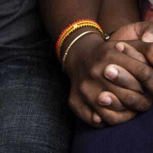 Celestine Mugisha and his wife, Winniefred Akello, embrace on the couch in their apartment in Rogers Park on the North Side, Jan. 30, 2020. Mugisha and Akello were married in Uganda in September 2016 and, days later, Mugisha moved to Chicago as part of the United States’ refugee resettlement program. More than three years later, Akello was also resettled through the program and the couple was reunited at O’Hare International Airport on Jan. 22, 2020.