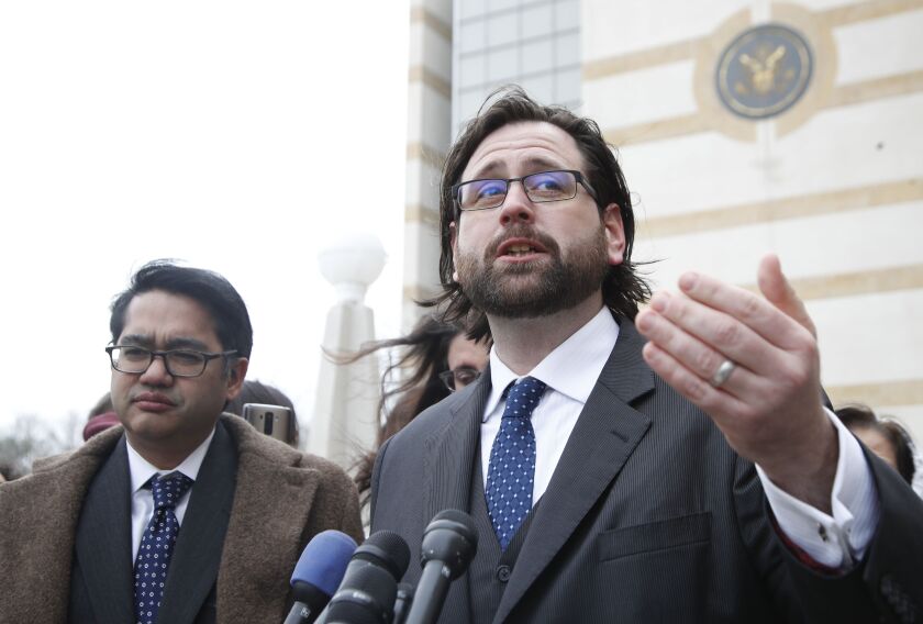 Justin Cox of the National Immigration Law Center (right), representing all the plaintiffs, accompanied by Omar Jadwat of the American Civil Liberties Union, speaks to reporters outside court in Beltsville, Md. on Wednesday. | Manuel Balce Ceneta/Associat