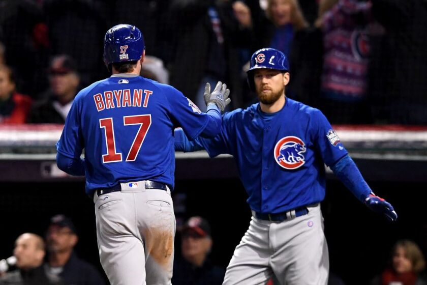 The very popular No. 17 jersey, as worn by Kris Bryant as he celebrates with Ben Zobrist Wednesday after scoring against the Cleveland Indians in Game Two of the World Series at Progressive Field. | Getty Images