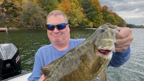 Patrick Kelly of Chicago with a 4-pound smallmouth bass from Big Green Lake. Provided by Mike Norris