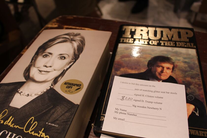 Book fair guests bid on signed copies of books by Hillary Clinton and Donald Trump. | Emily Moon/Sun-Times