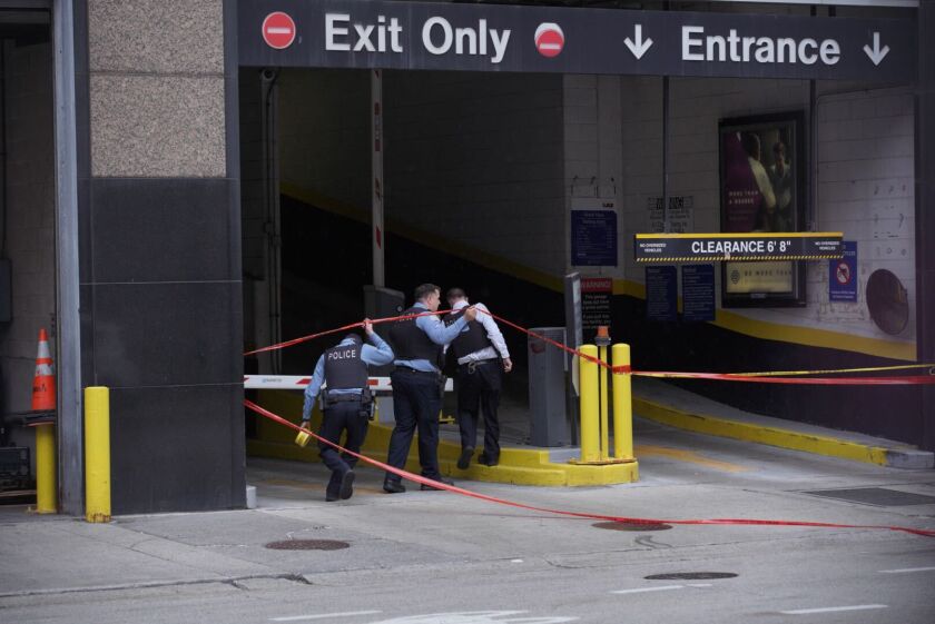 Chicago police investigate a shooting near Dearborn Street and Grand Avenue, May 15, 2021.