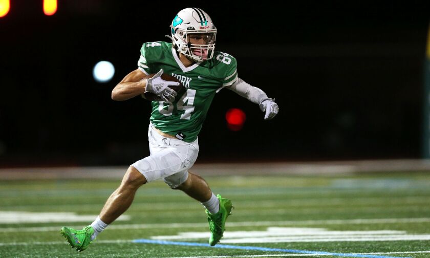 York’s Luke Mailander (84) catches a pass and turns up field last season against Glenbard West.