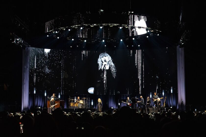 A video screen projects Stevie Nicks’s image as she performs at the United Center.