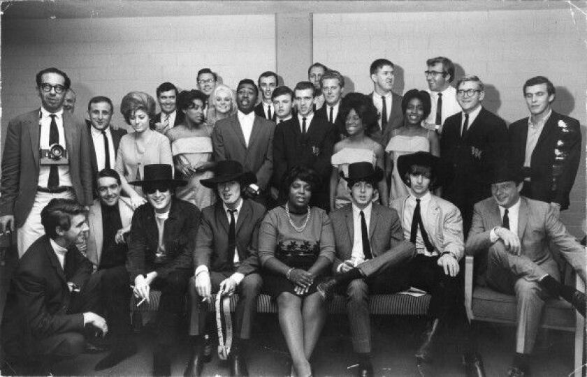 The entire Beatles tour entourage in 1964 in Chicago, including correspondent Ivor Davis (back left, just to the right of man with camera). |COURTESY EXPRESS NEWSPAPERS