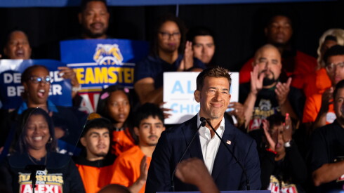 Secretary of State Alexi Giannoulias smiles at a podium as he announces his run for mayor at an event in Bronzeville on the South Side, Sunday, Aug. 2, 2026.