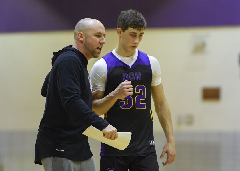 Downers Grove North’s Jack Stanton (32) and coach Jim Thomas confer during practice.