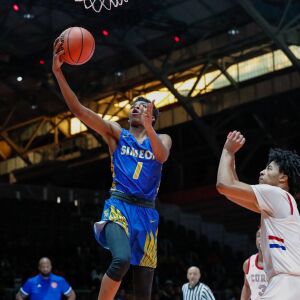 Simeon’s Jaylen Drane (1) takes the ball to the basket over Curie.