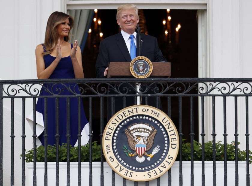 President Donald Trump, with first lady Melania Trump, spoke from the Truman Balcony at the Fourth of July picnic for military families on the South Lawn of the White House on Tuesday. | Alex Brandon/Associated Press