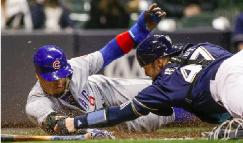 <em>Javy Baez slides around the tag to score from first in the third inning. AP</em>