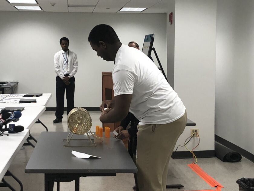Candidates’ names were placed in a ballot lottery box and spun in prescription bottles in the basement of 69 W. Washington St. | Tina Sfondeles