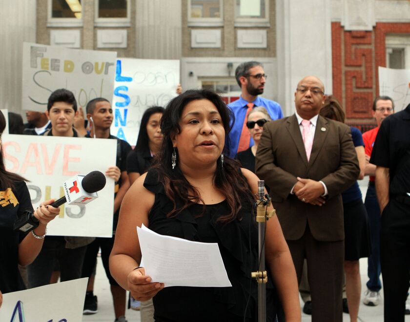 Maria Patino, a concerned parent, speaks at a protest about budget cuts at Kelvyn Park High School in Chicago on Monday. | Kevin Tanaka/For the Sun-Times