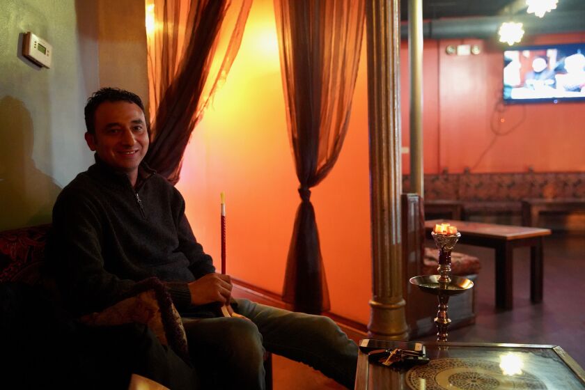 On Wednesday Jan. 15, 2020, Arabia Cafe Hookah Lounge owner Mounir Zekkari smokes a hookah.
